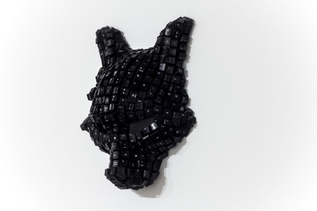 Sculptural mask created from black computer keys, contemporary fine art sculpture by African artist Maurice Mbikayi