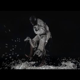 Video still from Maurice Mbikayi's performance art in his Web Jacket